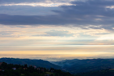 Scenic view of silhouette mountains against sky during sunset