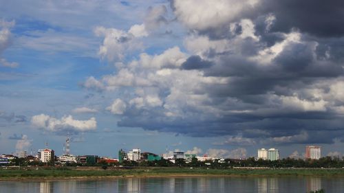 Scenic of the city along the river against sky.
