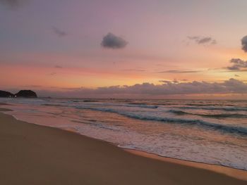 Scenic view of beach against sky during sunset