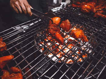 Man preparing food on barbecue grill