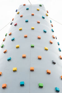 Low angle view of climbing wall against sky