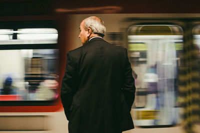 Rear view of man on train at railroad station