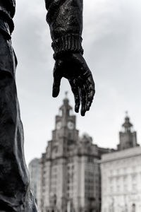 Low angle view of statue against historic building