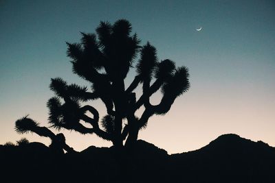 Silhouette of landscape against sky at sunset