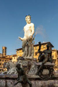 Low angle view of statue against clear blue sky