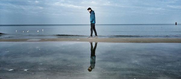 Man walking on sand bar