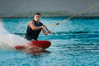 Full length of man splashing water