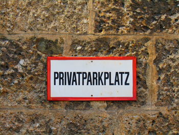 Close-up of information sign on wall