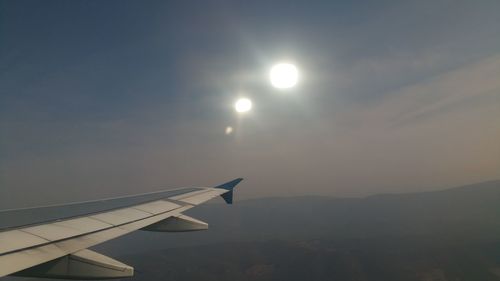 Airplane flying in sky during sunset