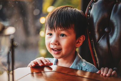 Close up shot of cute smiling child boy in the vintage house style.  a happy child enjoying life.