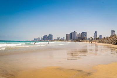 View of beach and buildings against sky