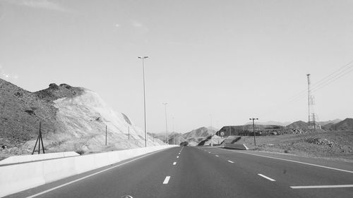 Cars on road against sky