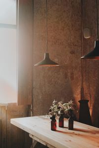 Potted plant on table against wall at home