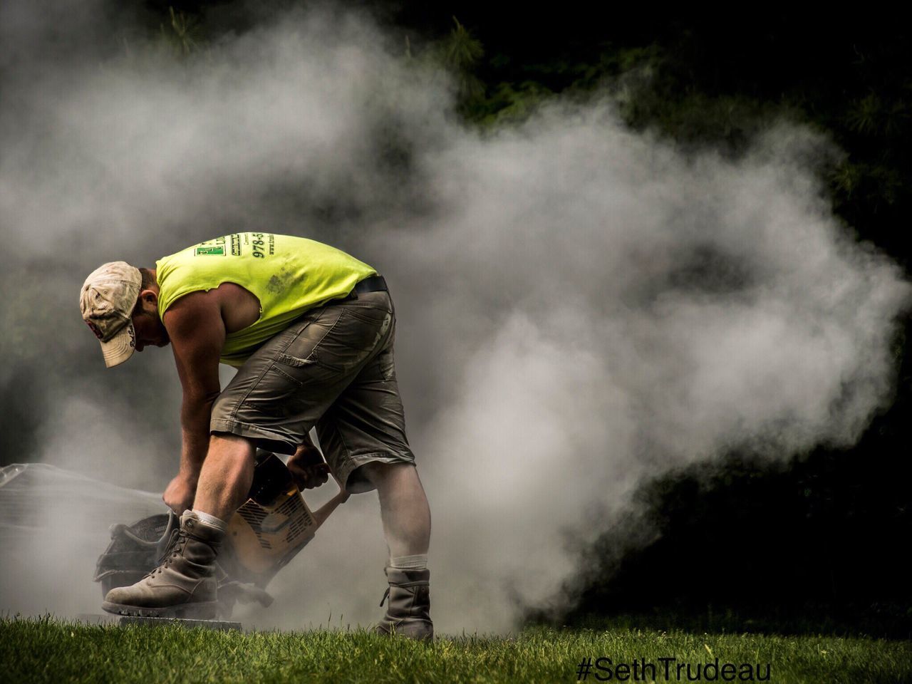 REAR VIEW OF MAN STANDING ON GRASS