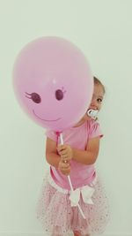 Portrait of cute girl holding balloons