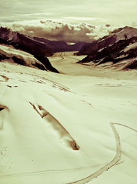 Scenic view of desert against sky during winter