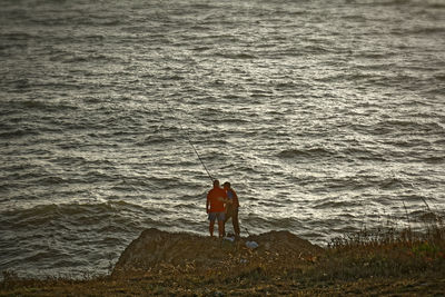 Rear view of man standing on beach