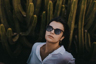 Close-up portrait of young woman against sunglasses