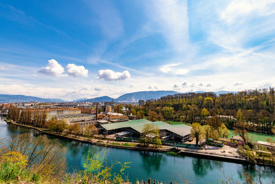 Scenic view of swimming pool by river against sky