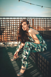 Portrait of young woman sitting outdoors