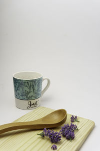 Coffee cup on table against white background