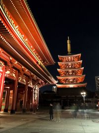 Illuminated temple against sky at night