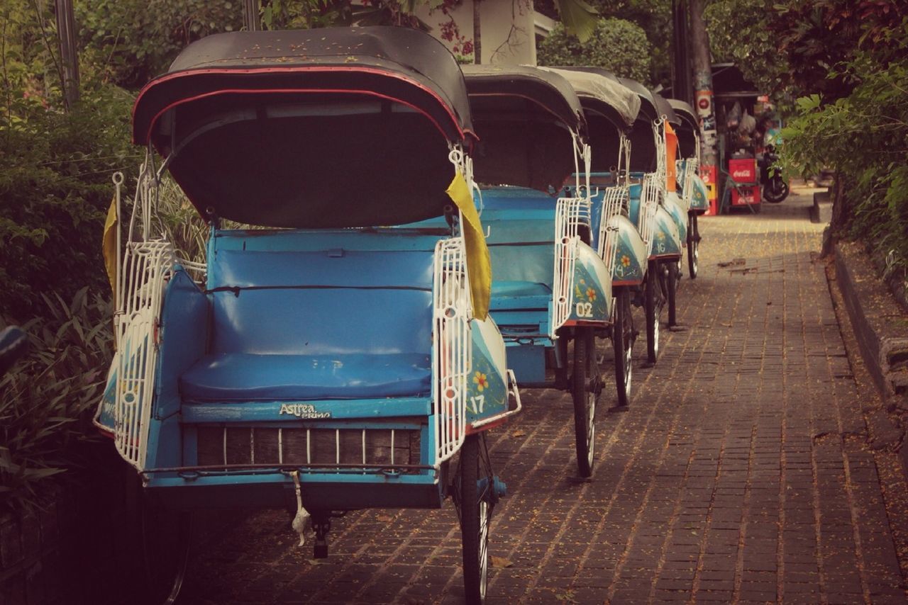 transportation, built structure, building exterior, architecture, the way forward, mode of transport, day, street, cobblestone, sunlight, outdoors, footpath, incidental people, in a row, sidewalk, empty, railing, men