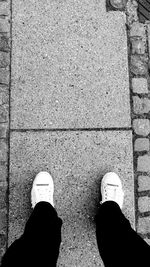 Low section of man standing on tiled floor