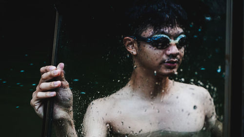 Portrait of handsome young man holding glass