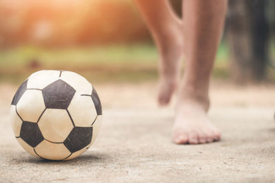 Low section of person playing soccer with ball