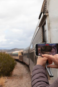 Taking a photo with the smartphone on the running train. desert view