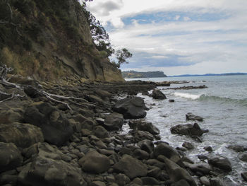 Rocks on beach against sky