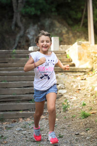 Portrait of happy girl standing outdoors