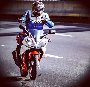 Man riding motorcycle on road