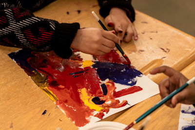 High angle view of woman painting on table