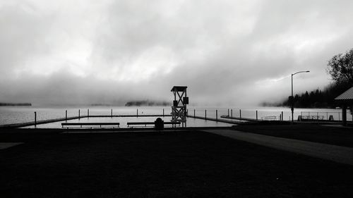 View of calm beach against clouds