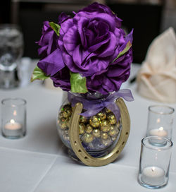Close-up of purple flower vase on table