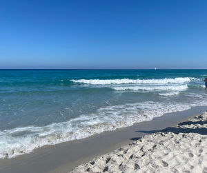 Scenic view of sea against clear blue sky