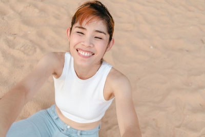 Portrait of smiling young woman on beach