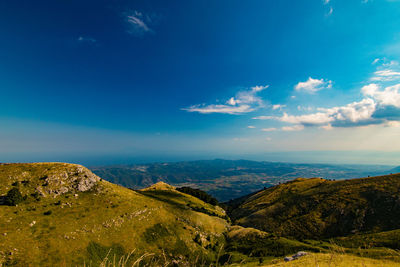 Scenic view of landscape against blue sky