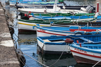 Fishing boats moored at harbor