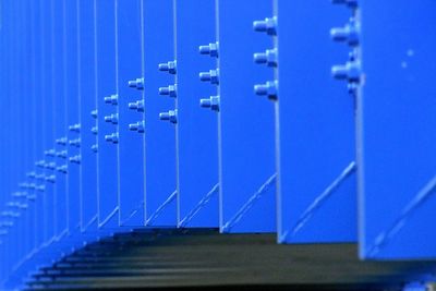 Close-up of metallic structure against blue sky