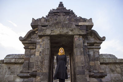 Muslim tourist woman wearing headscarf or hijab at plaosan temple, klaten, central java, indonesia