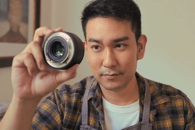 Portrait of young man photographing