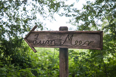 Low angle view of information sign against sky