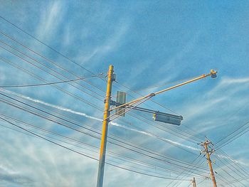 Low angle view of electricity pylon against sky