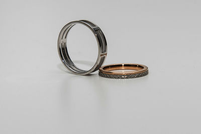Close-up of wedding rings on table against white background