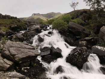 Scenic view of river flowing through rocks