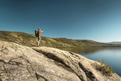 Man hiking near a beautiful lake