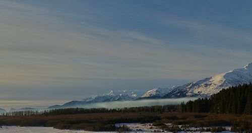 Scenic view of snowcapped mountains against sky during winter